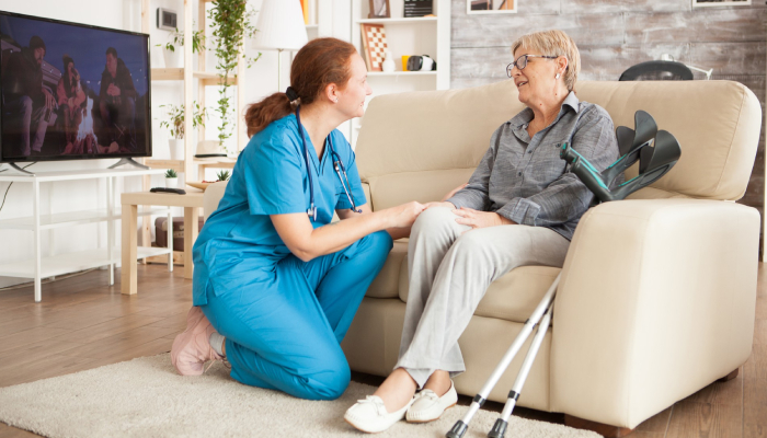 Compassionate NDIS support worker assisting a participant with daily personal care