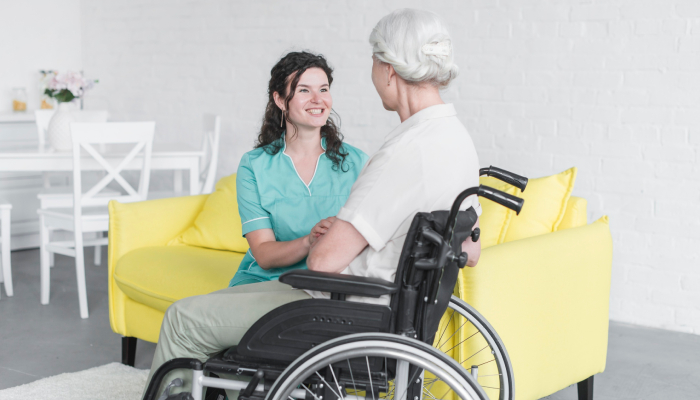 Caring NDIS disability support worker assisting participant with daily activities